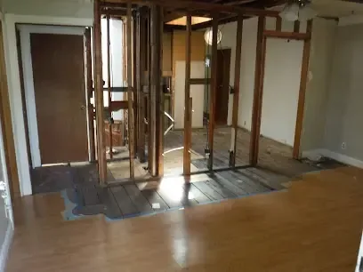 Flooring pulled up and walls stripped to the studs while a room dries out