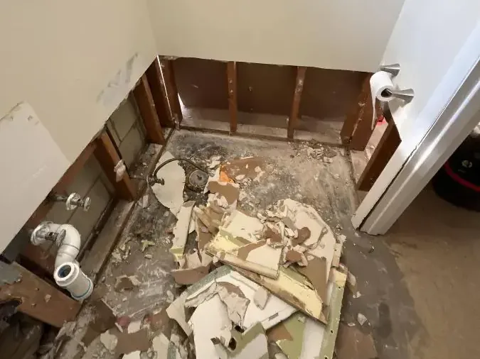A bathroom stripped to the studs with debris cleared after a sewage backup